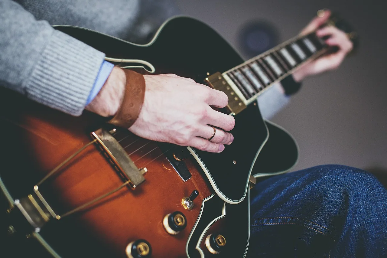 guitarist playing an acoustic guitar guitarist playing an acoustic guitar