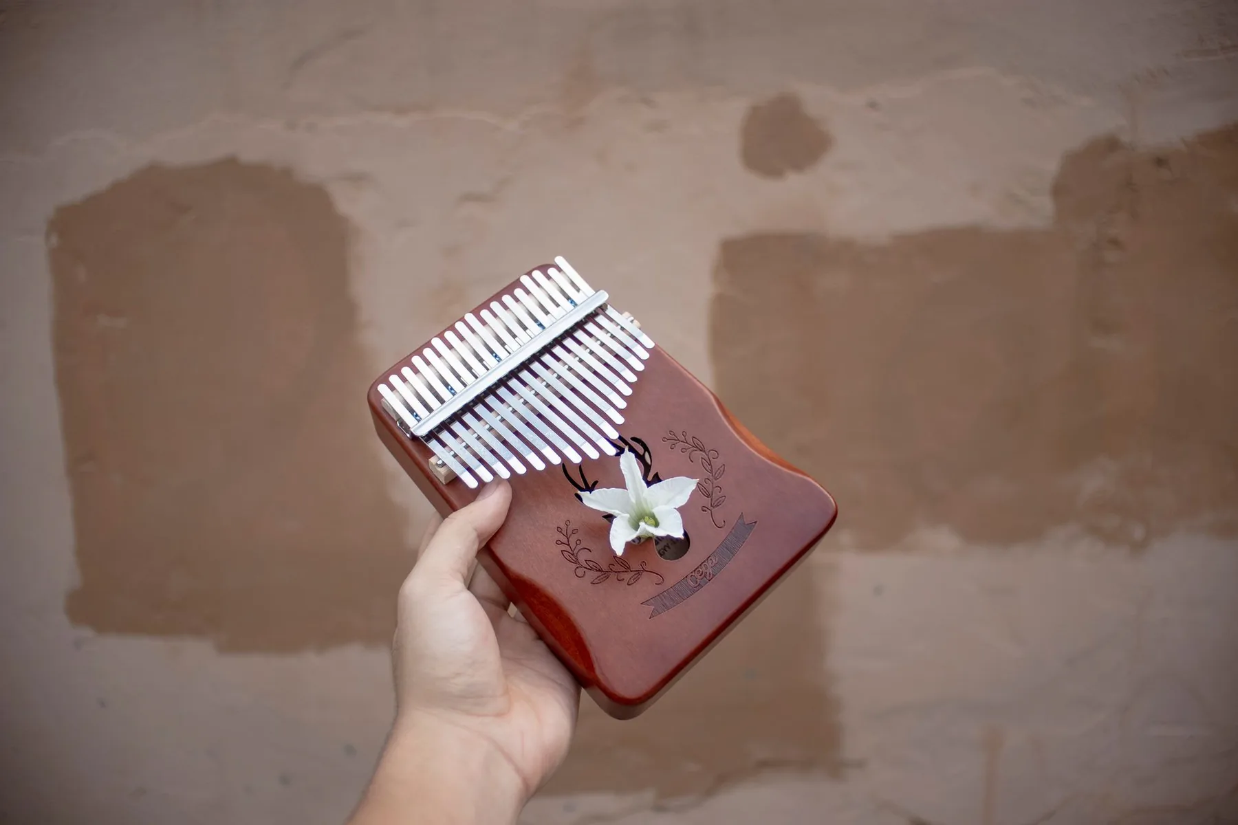 Wooden kalimba held in the hand