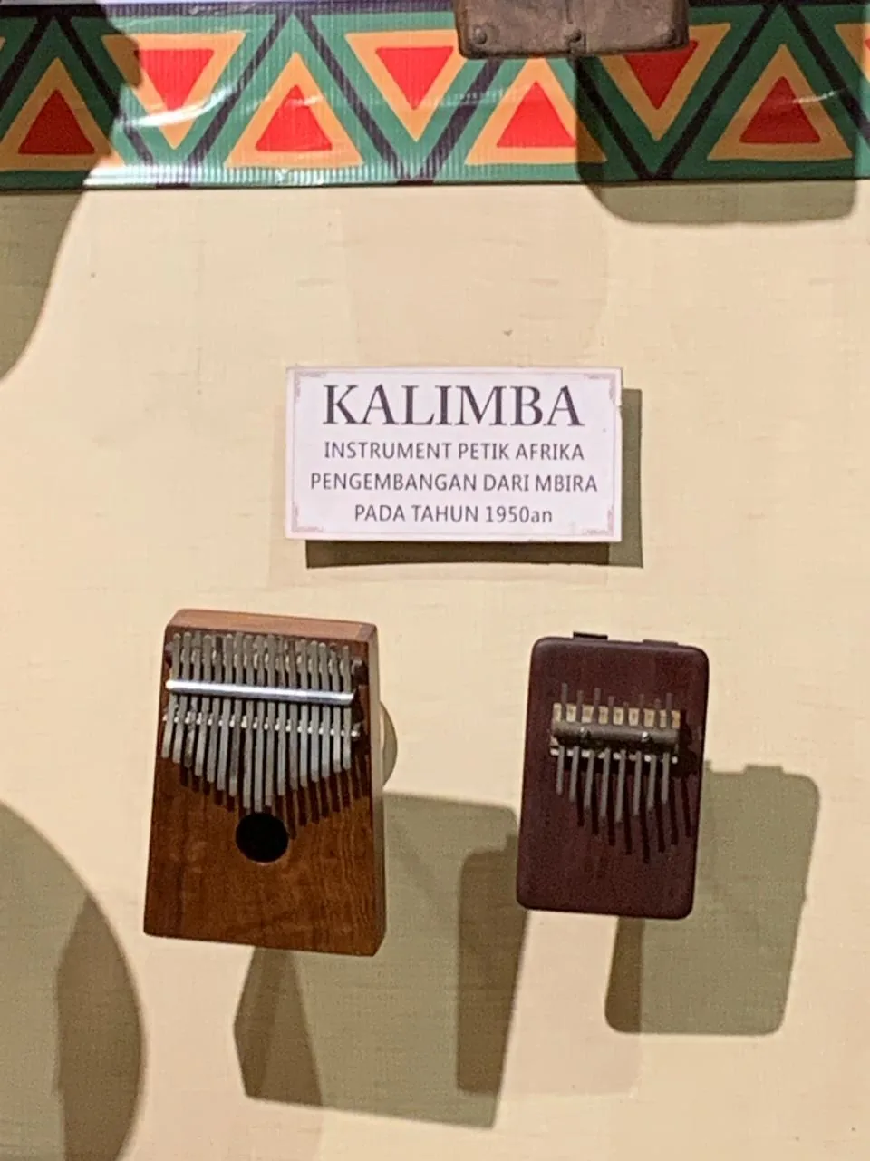 Wooden kalimbas displayed on a wall Wooden kalimbas displayed on a wall