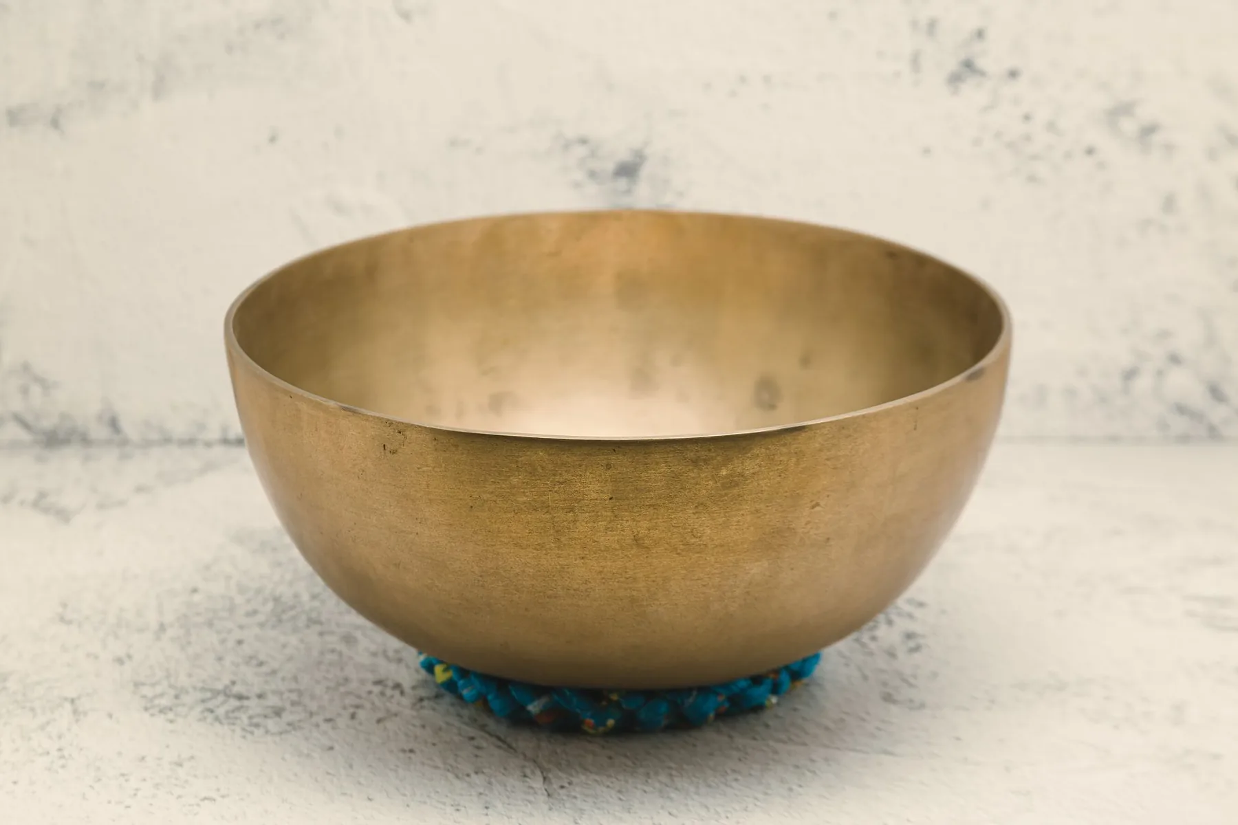 Tibetan singing bowl on a blue cushion Tibetan singing bowl on a blue cushion