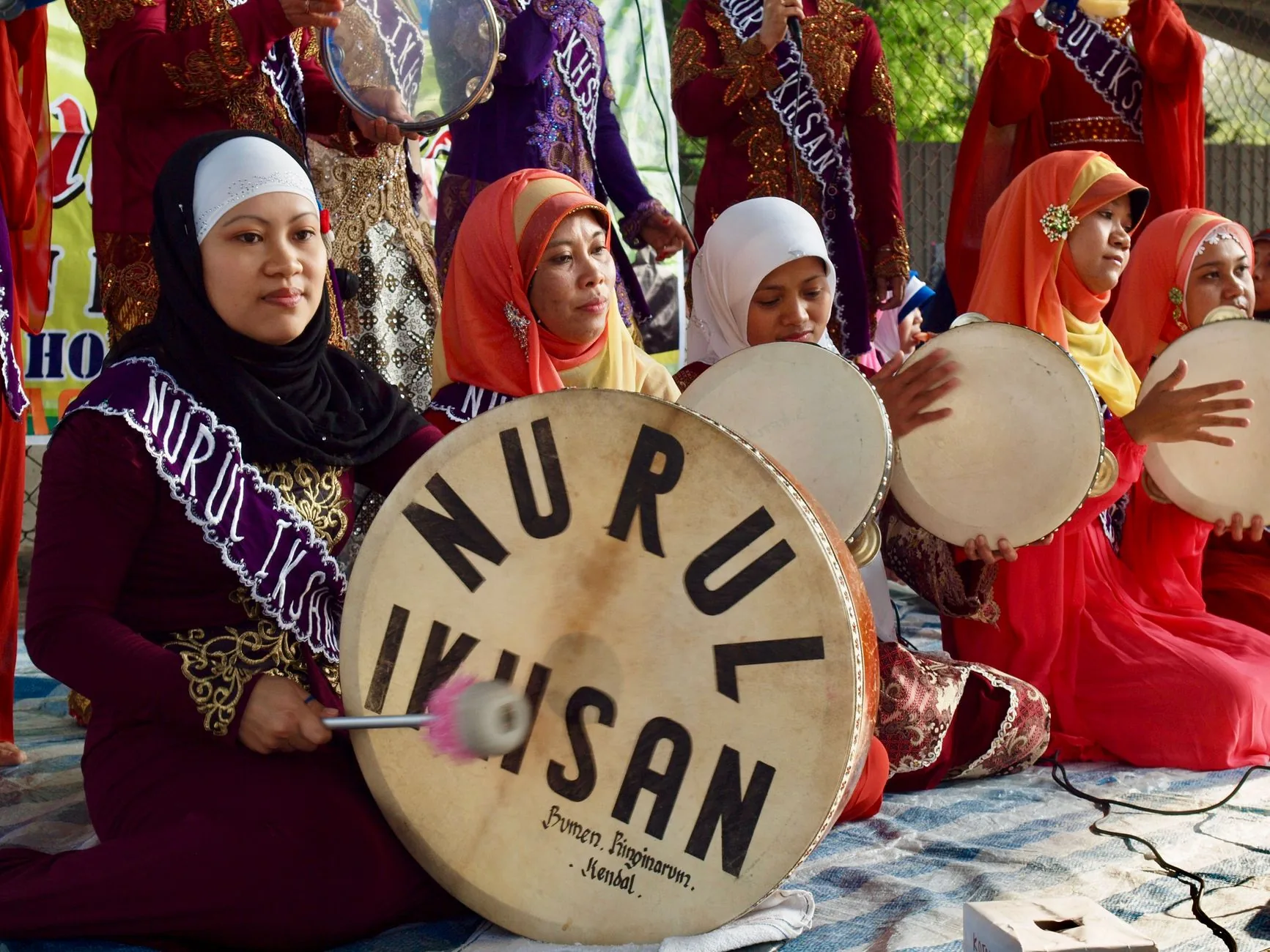 female musicians playing traditional drums