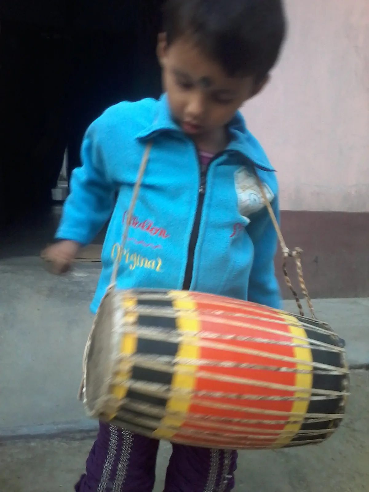 child playing a traditional drum child playing a traditional drum