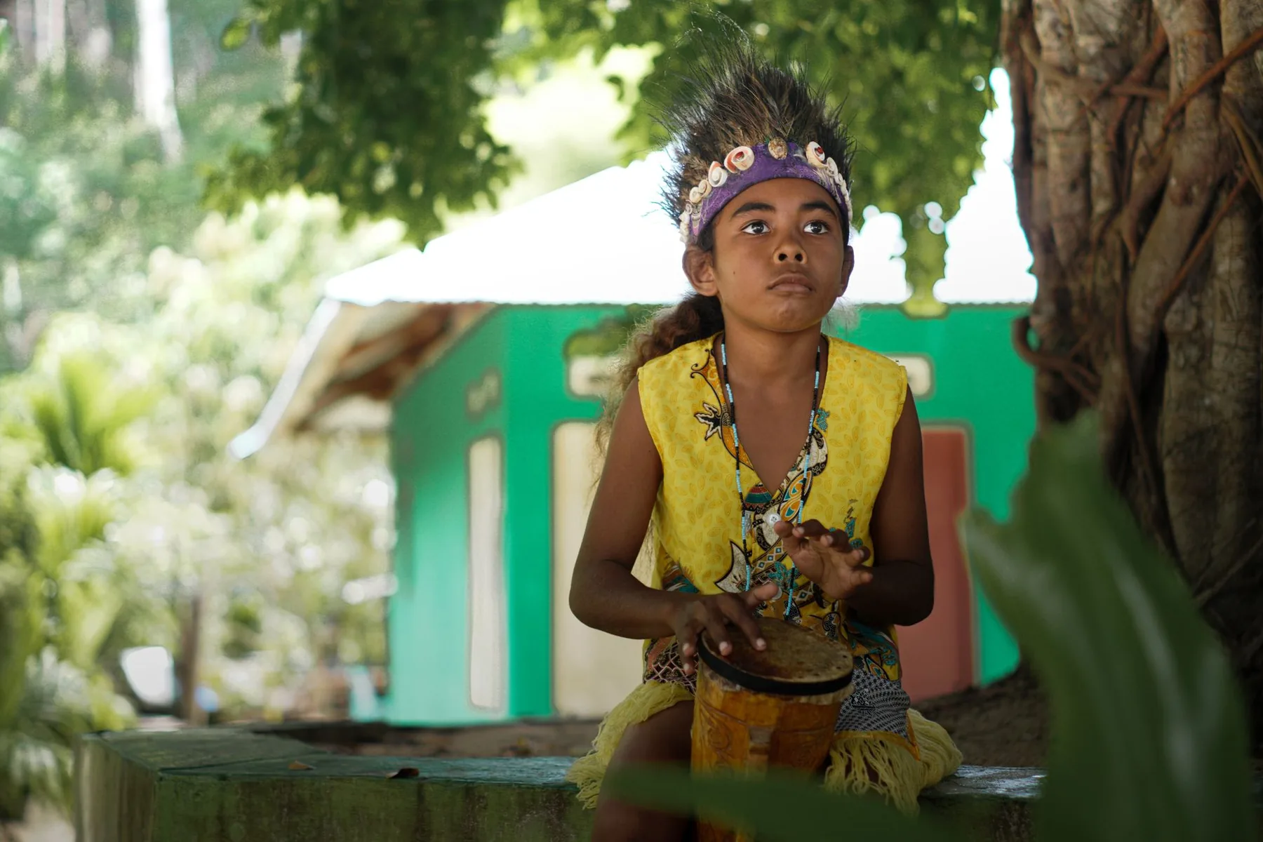 child playing a traditional drum