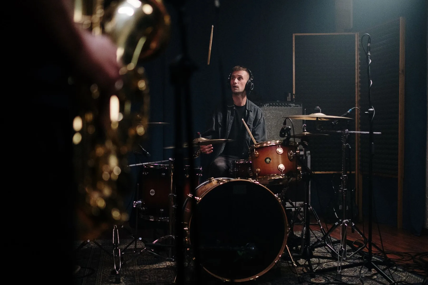 drummer in a studio with drumsticks