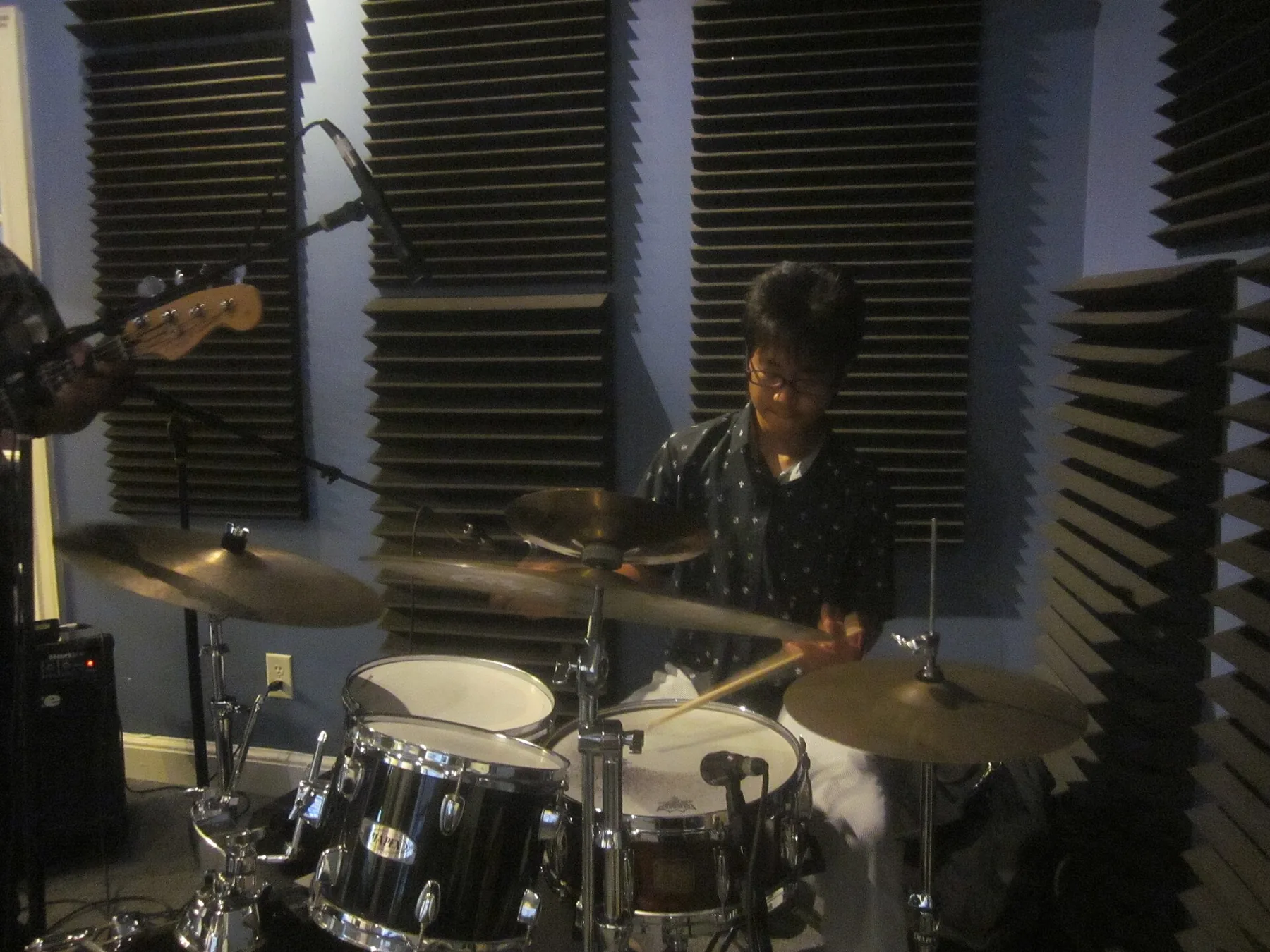 drummer playing an acoustic drum kit drummer playing an acoustic drum kit